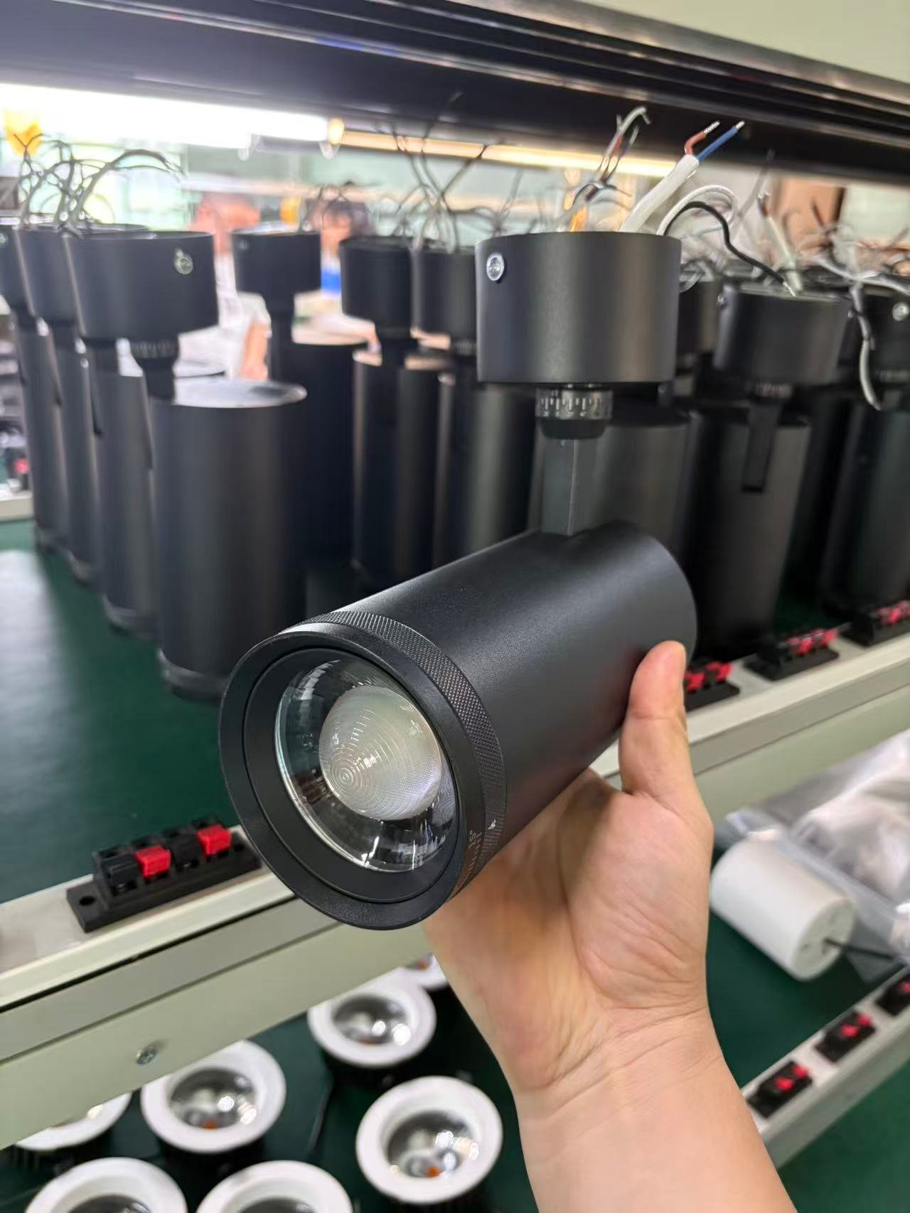 factory batch of led track light black housings undergoing quality inspection